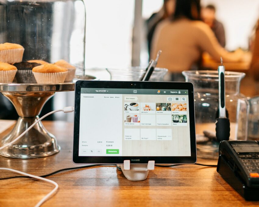 silver ipad on brown wooden table